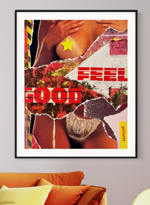 Framed artwork with abstract design and text 'FEEL GOOD' on a wall above an orange sofa.