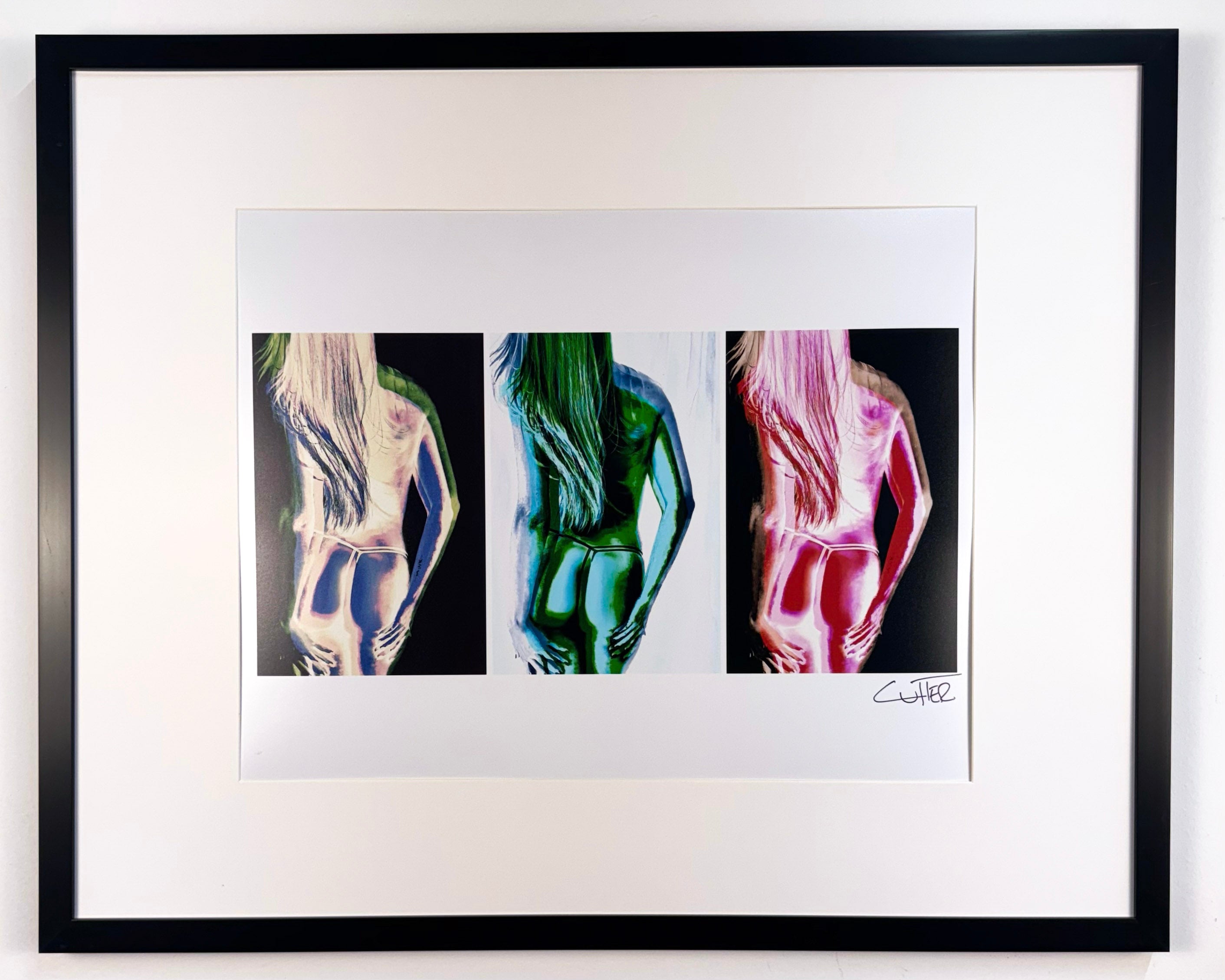 Framed artwork of abstract human figures in multiple colors on a white background