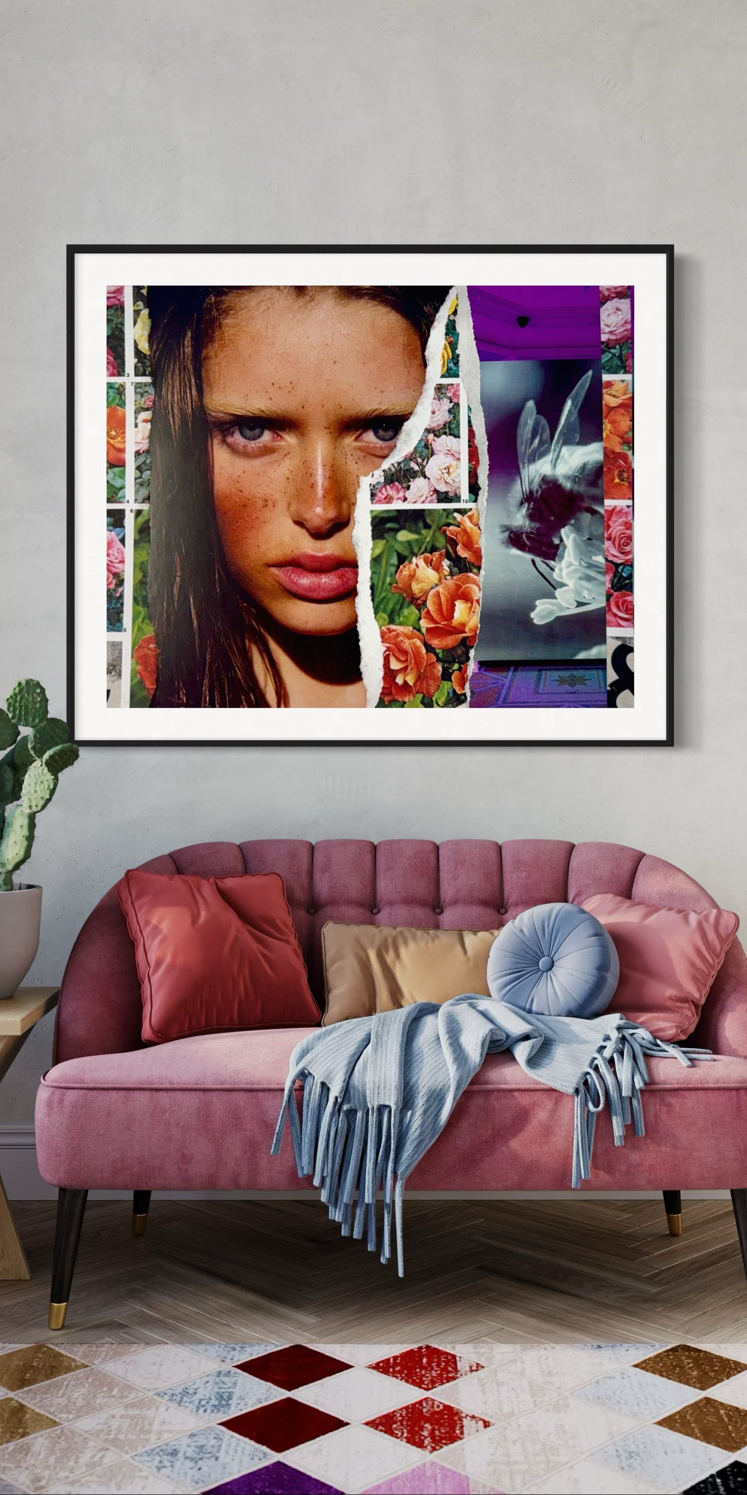 Framed artwork above a pink sofa with decorative pillows and a blanket.