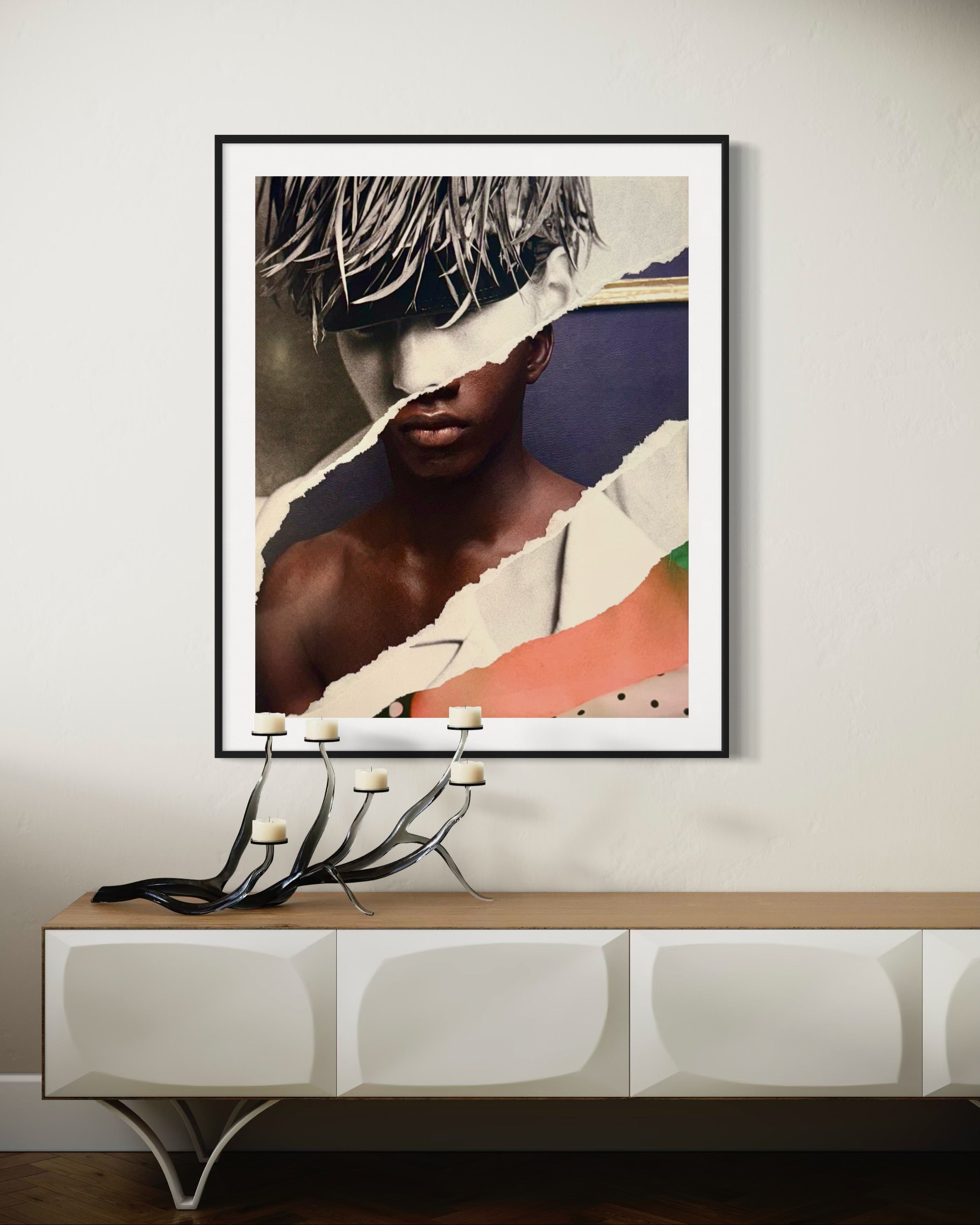 Framed artwork on a wall above a console table
